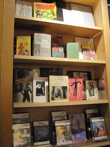 A shelf that has several vintage books.