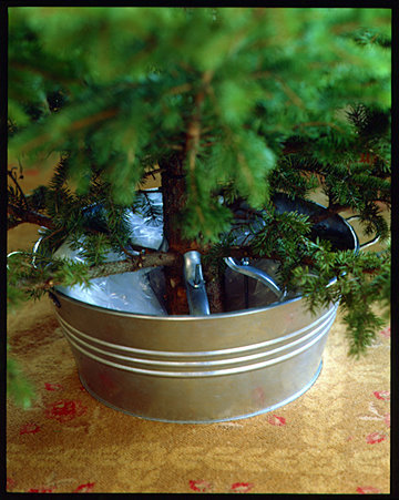 The tree and stand can be placed into a metal basin. The tree and stand can be placed into a metal basin.