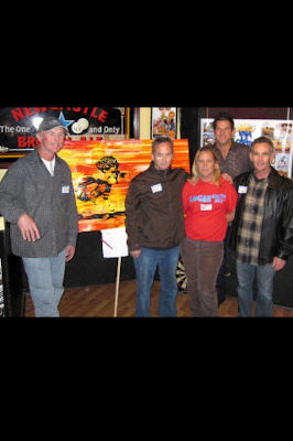 Brian standing next to a painting of Bruce then Bruce, Robin & Brad with the artist standing in the rear Erik Skoldberg. Brian places the highest bid when it was auctioned at the 2009 La Costa re-union