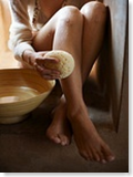 woman scrubbing her legs