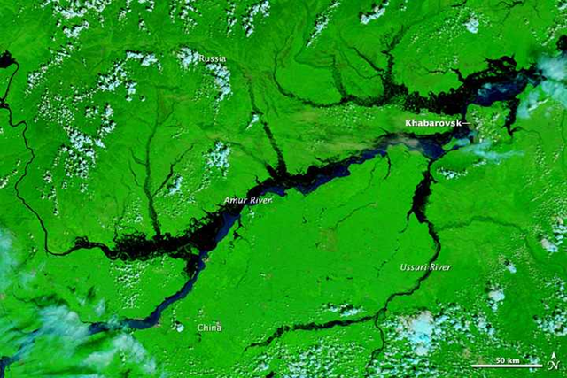 Satellite view of the Amur River near Khabarovsk in eastern Russia, 21 August 2013. In the city of Khabarovsk, the Amur River swelled to a record height of 696 centimeters (274 inches), the worst flood in Russia's history according to Alexander Frolov, chief forecaster of the national weather center. Photo: LANCE/EOSDIS MODIS Rapid Response Team / NASA GSFC