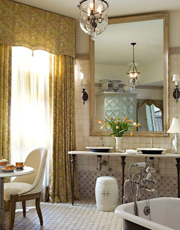 A tea table and floor to ceiling drapes in a bathroom -- wow!