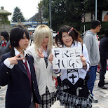 Japanese girls holding a Free Hugs sign in Harajuku, Tokyo, Japan