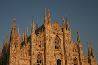 Upper facade of Milan Cathedral at sunset