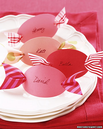 What could be sweeter? Cut out 3-inch ovals from colorful card stock. Using a hole punch, make a hole at each end, and then neatly write your guests' names on the ovals with black ink. Thread ribbon scraps, each about 6 inches long and 1 1/2 inches wide, through the backs of the place cards. Notch the ribbon ends, and set a card at each place setting. What could be sweeter? Cut out 3-inch ovals from colorful card stock. Using a hole punch, make a hole at each end, and then neatly write your guests' names on the ovals with black ink. Thread ribbon scraps, each about 6 inches long and 1 1/2 inches wide, through the backs of the place cards. Notch the ribbon ends, and set a card at each place setting.