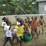 Watching their friends carry water cups to the other bucket.