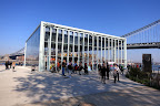 The carousel sits on the East River in Brooklyn Bridge Park, between the Brooklyn and Manhattan Bridges, housed in a spectacular acrylic pavilion, designed by French architect, Jean Nouvel.