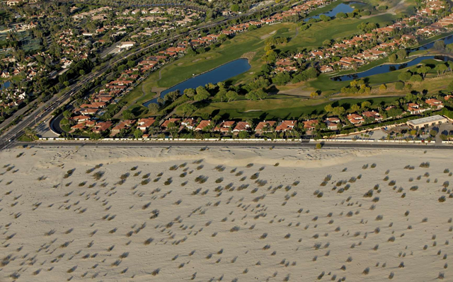 This 3 April 2015 aerial photo shows golf course communities bordering the desert in Cathedral City, California. In an aggressive push to reduce water usage statewide, California regulators are proposing that the biggest urban water users cut consumption by as much as 35 percent during 2015. Photo: Chris Carlson / AP Photo