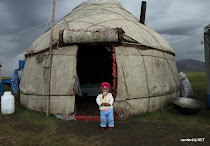 Kyrgyz girl posing in front of the yurt