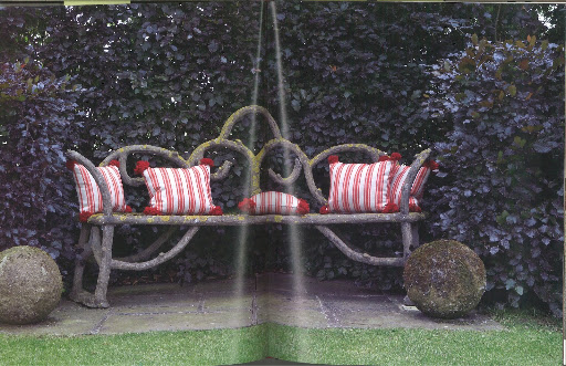 This garden bench is made of concrete and dates back to the 1930s. Yeoward writes that the pom-poms on the pillows refer back to the heavy concrete balls on the ground.
