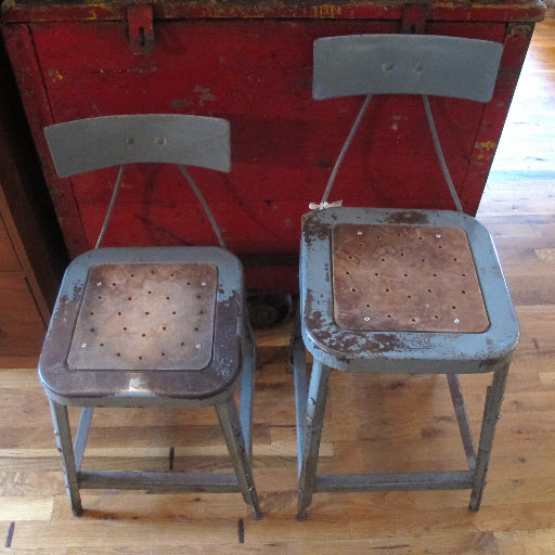 This set of blue metal chairs can be raised and lowered to match heights.