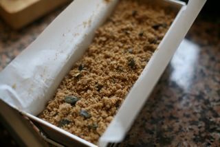 Once you've transferred the batter to a loaf pan, sprinkle the crumble topping evenly on top.