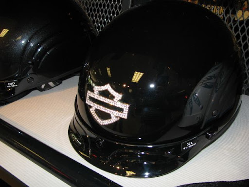 The store sells dozens of motorcycle helmets; this one is decorated with rhinestones.