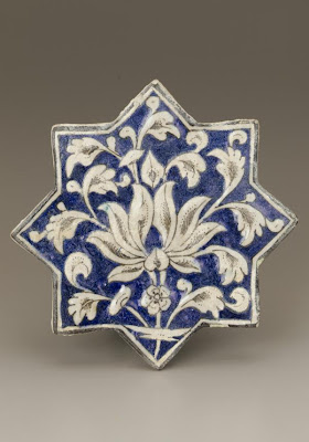 Star-shape tile | Origin:  Iran | Period: early 14th century  Il-Khanid period | Details:  Not Available | Type: Stoneware, composite body painted under clear glaze. | Size: H: 19.7  W: 19.7   D: 1.9  cm | Museum Code: F1999.12 | Photograph and description taken from Freer and the Sackler (Smithsonian) Museums.