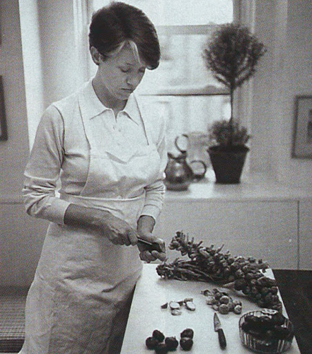 Ginny Millhiser cuts brussels sprouts in her kitchen on Thanksgiving morning.