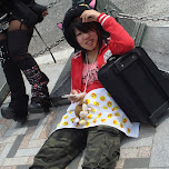 Japanese girl lying down on Jingu birdge in Harajuku, Japan 