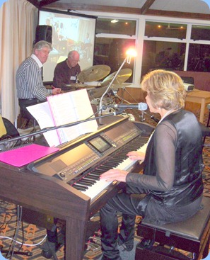 Carole Littlejohn singing with Len Hancy and Ian Jackson keeping the beat and Peter Brophy adding keyboard harmonies.