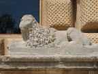 A lion sculpture on the side of the palace of Charles V in the Alhambra.