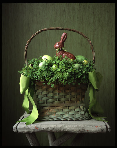 This chocolate bunny looks right at home atop the green meadow in this basket.