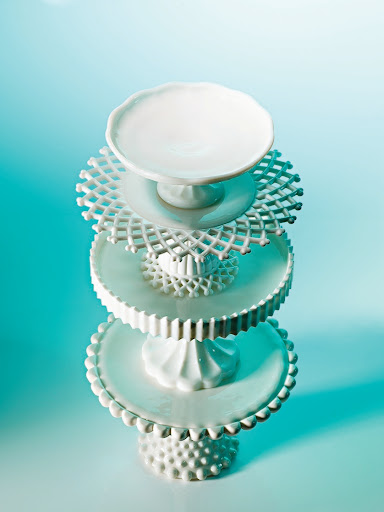 In the 18th century, European glassmakers created milk glass to mimic porcelain. After clear glass, it's the easiest to find. Some of these stands have intricate patterns on the undersides of the tops. In the 18th century, European glassmakers created milk glass to mimic porcelain. After clear glass, it's the easiest to find. Some of these stands have intricate patterns on the undersides of the tops.