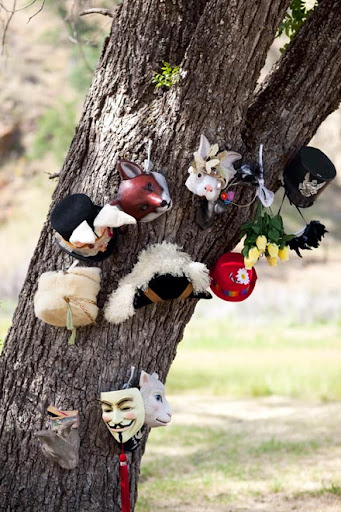We have an extensive hat collection which we pulled together to use as props for the photobooth--including a marching band hat and a top hat I had augmented with velveteen rabbit ears and millinery bits for an Alice in Wonderland party. I also found some great animal masks and covered them in vintage glass glitter. 
Photo by Gia Canali.