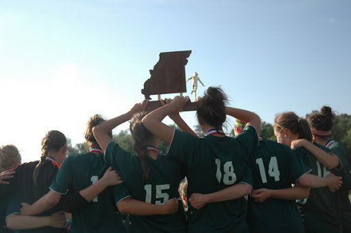 Despite having exercise-induced asthma, Smid plays as a midfielder on the soccer team; this photo is of her and her teammates from Springfield's Catholic High celebrating after winning the state championships in soccer this year. (Photo used with permission from Natalie Smid)