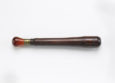 Burnisher | Origin:  Turkey | Period: 19th century  Otoman period | Details:  Not Available | Type: Carnelian, brass, rosewood | Size: H: 10.5  W: 1.5   D: 1.5  cm | Museum Code: S1990.68 | Photograph and description taken from Freer and the Sackler (Smithsonian) Museums.
