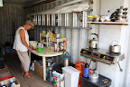 Bev preparing a meal inside her 20ft container “kitchen”