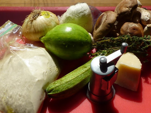 Ingredients assembled for the pizza (two different types of zucchini, the one that looks like an avocado is called an avocado squash).