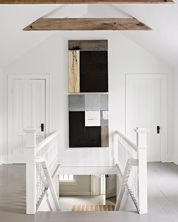 This stark white landing is punctuated by abstract art, completing the pared-down look.