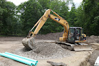 Now they're back filling around the foundation with drainage pipes and gravel and will next start working on the floor.