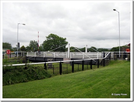 Road swing bridge across the lock up into the canal basin. Glasson dock.