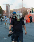 Photojournalists were well-equipped. Note the three photographers in rear getting close to the orange smoke... This is our modern condition.