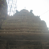 View of the roof of this mukha-mandapa. The Sun was not in right direction so the photo is not very clear. This roof is a recent addition to the temple. Various dancers' images are sculpted on the horizontal strip. In the central panel is shown a goddess under a makara-torana sitting over her mount.