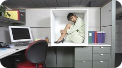 Businesswoman sitting in office cubicle