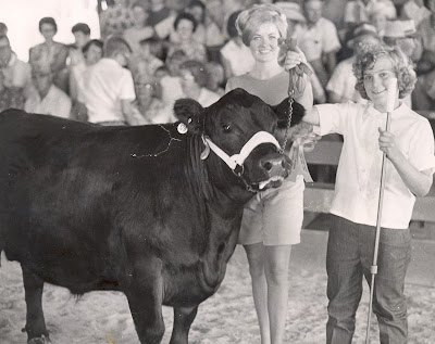 Janice (Schneider) Carr remembers how 4-H was always a family event travelling to the State Fair and Cattle Congress.  She showed beef during her 10 years in 4-H for the Clover Cloverettes 4-H club. Here Queen Abbie (Timmins) Parmele awards Carr during a beef show in 1967.  She said one of her favorite 4-H highlights were the trips to Washington D.C.    Carr's three children were a part of  Washington County 4-H and now she serves on the Youth Committee.  Photo Courtesy:  Washington County Extension.