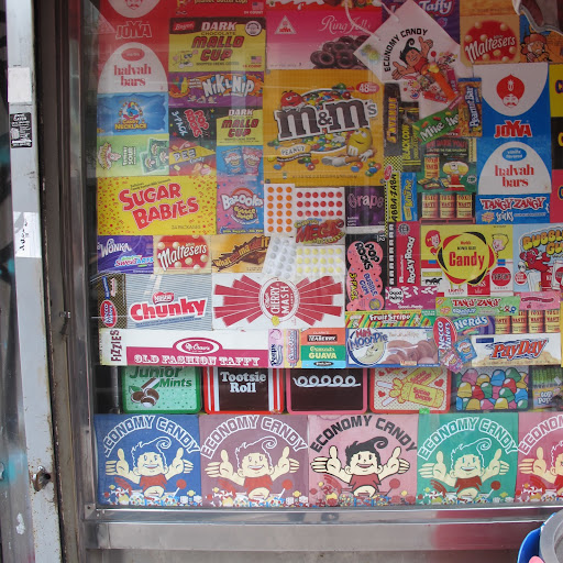 Labels coat the storefront windows. Economy is known for its commitment to old fashioned candies and new trends alike, which is one of the reasons I love it. Labels coat the storefront windows. Economy is known for its commitment to old fashioned candies and new trends alike, which is one of the reasons I love it.