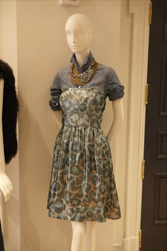 A great strapless dress is paired with a jean shirt and a fantastic necklace. A great strapless dress is paired with a jean shirt and a fantastic necklace.