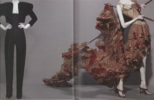 The black outfit, when paired with a hat, resembles the traditional toro outfit. The red patterned dress has a similar Spanish flare. 