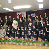 All the kids, parents, and teachers. Kai's in the middle of the front row, and Maria, Eidan, and I are in the back, on the right.