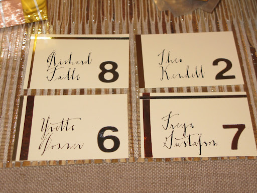 Escort Cards from the metallic story!  Vinyl numbers from Duall​.
Crane & Co. escort cards.
Nasco metallic Mylar craft tape.
 Art­Emboss copper foil tape from Robert's​ Crafts.
Canford card stock in metallic silver from NY Central Art Supply.
 Caligraphy by Diva Pyari of Linea Carta.