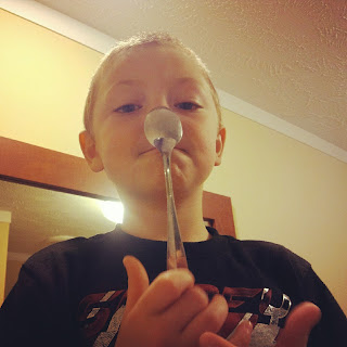 Grandboy holding a spoon on his nose