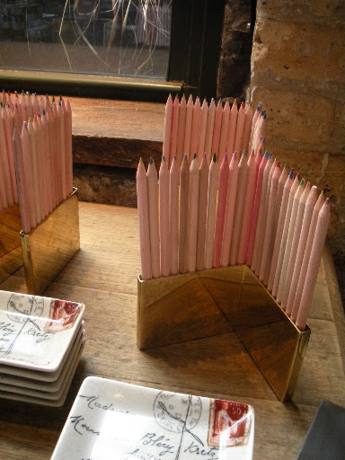Cleverly designed pencil holders make pretty desk decorations.