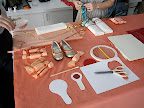 One of our work stations. The coral, red, and peach work station, apparently. That's me and our intern Stephanie working on the ring pillows.