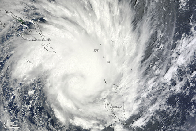 Raging over the southern Pacific Ocean, Tropical Cyclone Yasi easily spanned the distance between the Solomon Islands and Vanuatu on January 30, 2011. The Moderate Resolution Imaging Spectroradiometer (MODIS) on NASA’s Terra satellite captured this natural-color image at 10:20 a.m. on January 31 in New Caledonia time. Although lacking a discernible eye, Yasi sports the spiral shape characteristic of powerful storms. NASA image by Jeff Schmaltz, MODIS Rapid Response Team at NASA GSFC