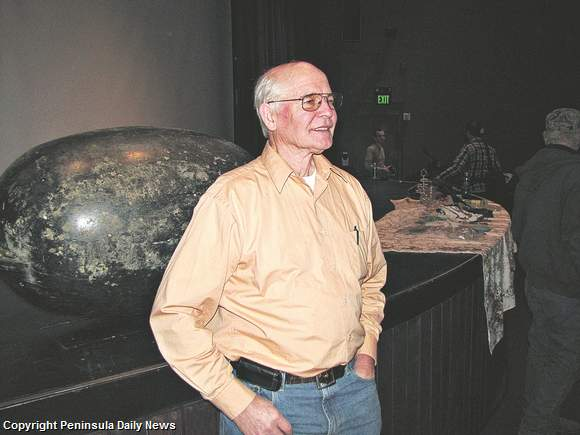 Oceanographer Jim Ingraham answers questions about the islands of debris from the March 11 Japan tsunami that are slowly floating toward the Pacific Northwest, 13 December 2011. Behind him is a float, found east of Neah Bay, that is believed to be the first identified piece of wreckage to arrive via ocean currents. Arwyn Rice / Peninsula Daily News