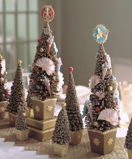 A Victorian time traler would delight at the detail in our miniature evergreen grove. Tiny medallions top the trees, and sequin snowflakes spangle their boughs. The table runner is embossed wallpaper painted gold, its border serrated by cutting along the diamond pattern. A Victorian time traler would delight at the detail in our miniature evergreen grove. Tiny medallions top the trees, and sequin snowflakes spangle their boughs. The table runner is embossed wallpaper painted gold, its border serrated by cutting along the diamond pattern.