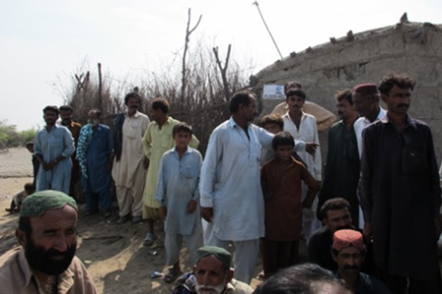 Flood-hit farmers in the arid village of Qaim Khan in the disaster-prone district of Badin, Sindh province attended an outdoor meeting near a flooded paddy field. Plan International via Reuters