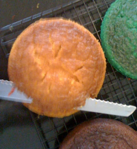 Cakes naturally bake with a bit of a dome. Once you've taken them out of their pans and they are completely cool, use a long serrated bread knife to slice this off this dome so that you have a relatively flat surface on both sides of each layer. Cakes naturally bake with a bit of a dome. Once you've taken them out of their pans and they are completely cool, use a long serrated bread knife to slice this off this dome so that you have a relatively flat surface on both sides of each layer.