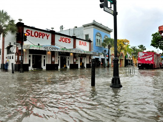 This Thursday, 2 May 2013 photo shows flooding on Duval Street in Key West, Florida, after roughly five inches of rainfall. In many sea level projections for the coming century, the Keys, Miami, and much of southern Florida partially sink beneath potential waves. Photo: Rob O’Neal / The Key West Citizen / Associated Press